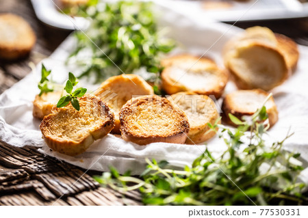 Crispy goldish bake rolls with savory flavour, served with lovely green thyme Crispy goldish bake rolls with savory flavour, served with lovely green thyme 77530331