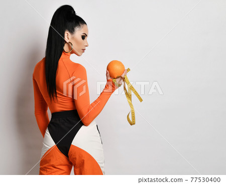Young woman in bright orange sportswear and Young woman in bright orange sportswear and 77530400