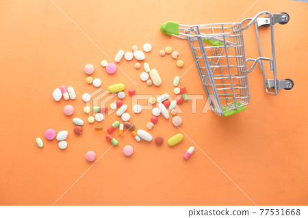 top view of many colorful pills, capsules and shopping card  77531668