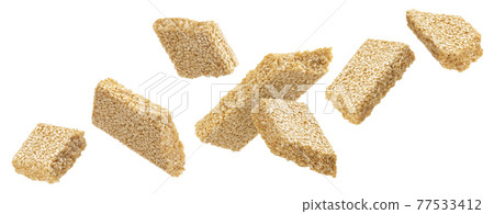 Falling sesame kozinaki isolated on white background Falling sesame kozinaki isolated on white background 77533412