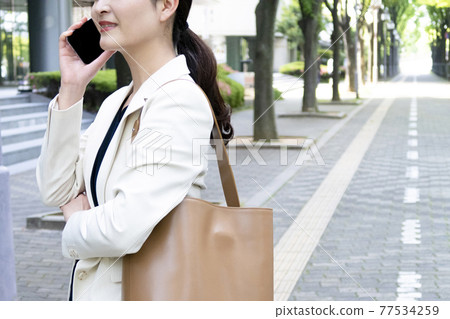 Business scene, woman, smartphone Business scene, woman, smartphone 77534259