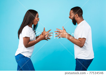 Black couple arguing, woman and man yelling at each other Black couple arguing, woman and man yelling at each other 77534546