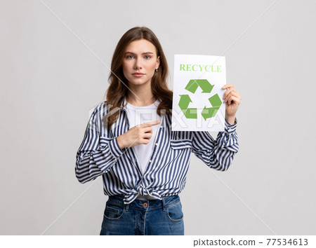 Importance Of Recycling. Millennial Eco-Activist Lady Demonstrating Placard With Green Recycle Sign 77534613