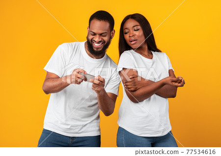 Addicted Man Using Phone, Black Woman Is Angry 77534616