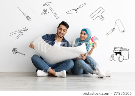 Creative muslim couple working on design for new house 77535105
