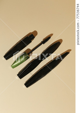 Isolated mascara on neutral backfround. Open with brush, black. Focus on brush Isolated mascara on neutral backfround. Open with brush, black. Focus on brush 77536744