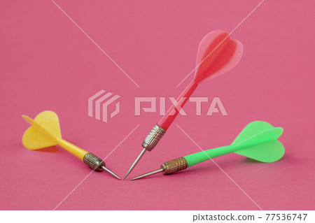 Three dart arrows on the pink background Three dart arrows on the pink background 77536747