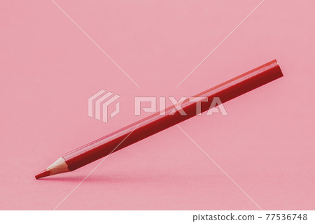 Red color pencil levitating over a pink background Red color pencil levitating over a pink background 77536748