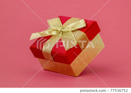 Gift box on pink paper background 77536752