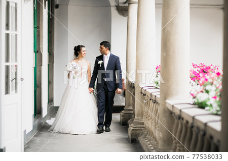 Wedding couple holding hands, groom and bride together on wedding day 77538033