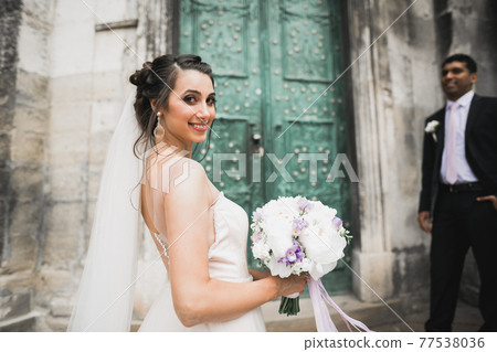 Wedding couple on the nature is hugging each other. Beautiful model girl in white dress. Man in suit Wedding couple on the nature is hugging each other. Beautiful model girl in white dress. Man in suit 77538036