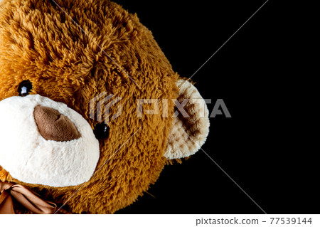 Brown Teddy Bear Leaning Into the Frame on Black Brown Teddy Bear Leaning Into the Frame on Black 77539144