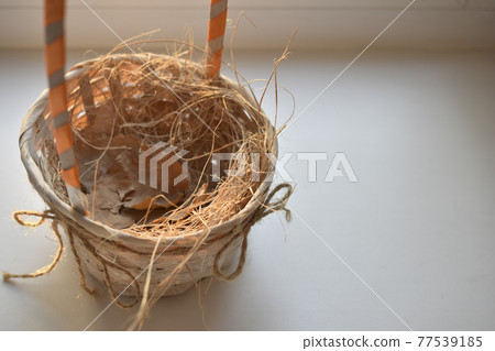Empty yellow knitted basket on white background 77539185