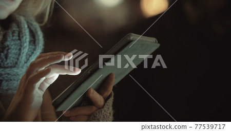 Female Typing on Tablet PC Outdoor 77539717