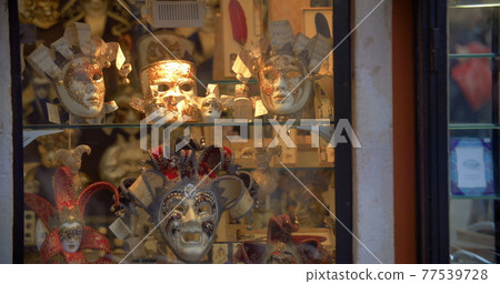 Venetian masks in glass show-window 77539728