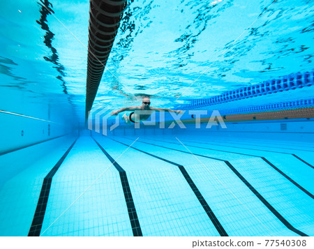 swimming in the pool at the swimming stadium 77540308