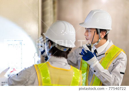 Workers using transceivers at construction sites 77540722