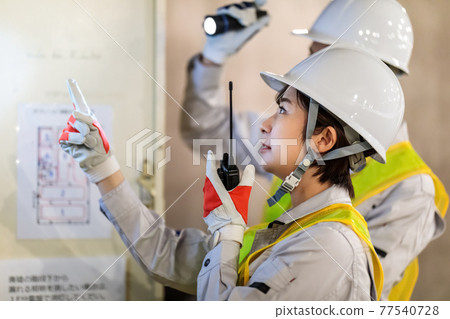 Workers using transceivers at construction sites 77540728