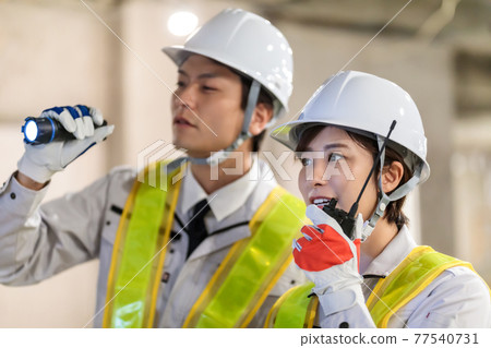 Workers using transceivers at construction sites Workers using transceivers at construction sites 77540731