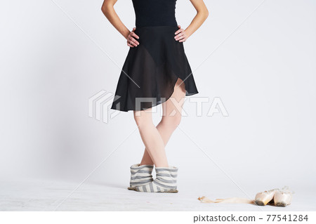 Ballerina legs in striped socks and pointe shoes dance light background model Ballerina legs in striped socks and pointe shoes dance light background model 77541284