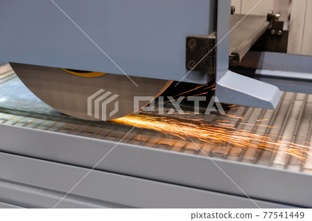 Surface grinding wheel machine working with sheet metal with sparks at factory Surface grinding wheel machine working with sheet metal with sparks at factory 77541449