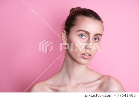 Beautiful young woman with clean fresh skin on pink background, Face care, Facial treatment, Cosmetology, beauty and spa, women portrait Beautiful young woman with clean fresh skin on pink background, Face care, Facial treatment, Cosmetology, beauty and spa, women portrait 77541498