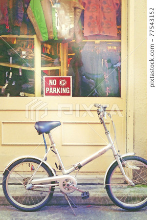 In front of the façade of a parked bicycle boutique In front of the façade of a parked bicycle boutique 77543152