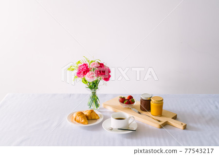 Flowers on the table breakfast 77543217