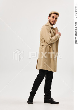man in coat holding collar fashion full growth lifestyle man in coat holding collar fashion full growth lifestyle 77544969