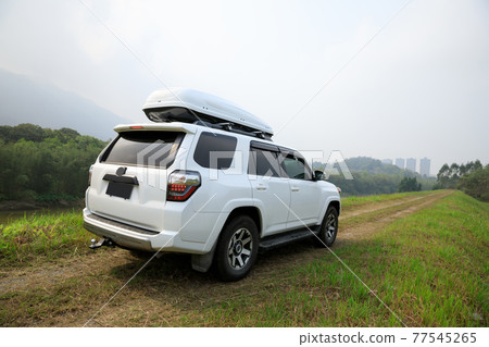 Offroad car on spring trail in mountains 77545265