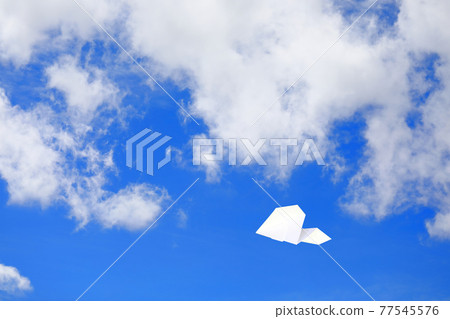 Paper plane flying in the sky 77545576