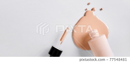 Banner with Mockup glass bottle of correction cosmetic product with pipette. Spilled Liquid foundation. Beauty branding concept 77548481