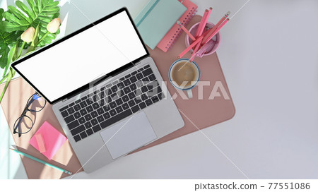 Top view of modern workspace with laptop, pencil holder, coffee cup and houseplant. 77551086