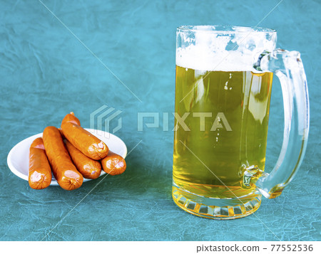 A mug of beer and Bavarian sausages. A mug of beer and Bavarian sausages. 77552536
