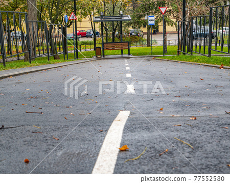 Empty road with a public transport stop. 77552580