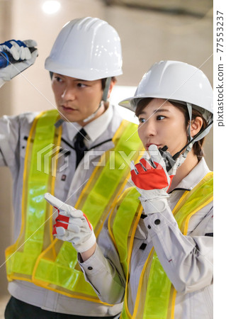 Workers using transceivers at construction sites Workers using transceivers at construction sites 77553237