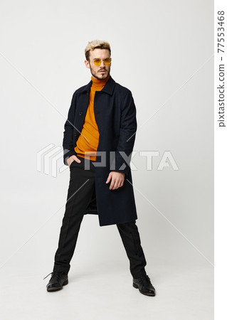 guy in a dark coat orange sweater pants suit model guy in a dark coat orange sweater pants suit model 77553468