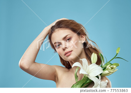 Attractive Lady white flowers blue background portrait cropped view Attractive Lady white flowers blue background portrait cropped view 77553863