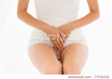 Woman holding her crotch 77556192
