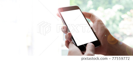 Woman hand holding smartphone with blur bokeh. Blank screen mobile phone for graphic display montage 77559772