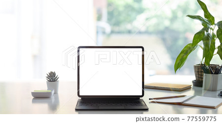 Digital tablet with white blank screen on table. workspace in modern office concept. Digital tablet with white blank screen on table. workspace in modern office concept. 77559775