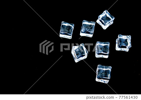 Clear ice in cube shape. Frozen water.Fake or Artificial acrylic or plastic ice cubes. Black background.copy text food background. 77561430