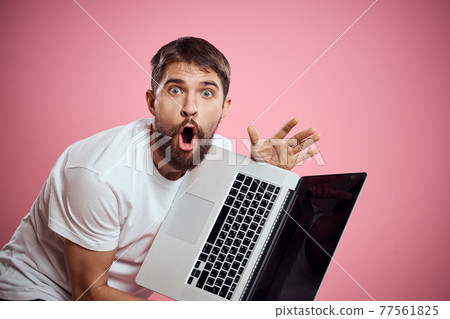 A man with an open laptop white t-shirt gestures with his hands cropped view new technology keyboard monitor 77561825