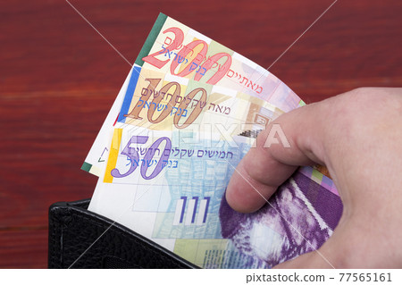 Banknotes from Israel in a black wallet Banknotes from Israel in a black wallet 77565161