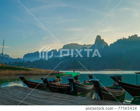 Lake of the morning mist and long tail boat (Khao Sok National Park, Surat Thani Province, Kingdom of Thailand) 77565419