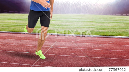 Composition of low section of male athlete running on track in sports stadium Composition of low section of male athlete running on track in sports stadium 77567012