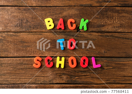 Back to school. Text on vintage wooden background. Top view 77568411