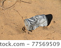 Saudi Arabia, an empty can that is abandoned in the middle of the desert and decays 77569509