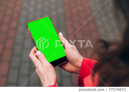 Cropped shot view of woman's hands holding smart phone with blank copy space screen for your text message or information content, female reading text message 77570672