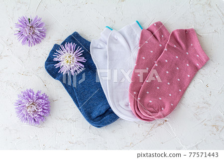 Three pair of women socks on pink background. Three pair of women socks on pink background. 77571443
